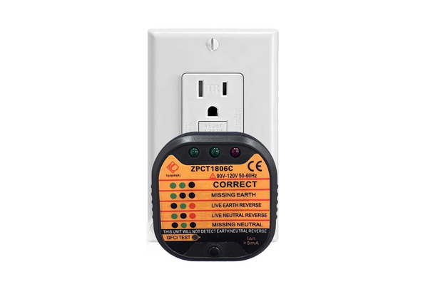 Outlet Grounding Tester plugged into a white wall outlet.