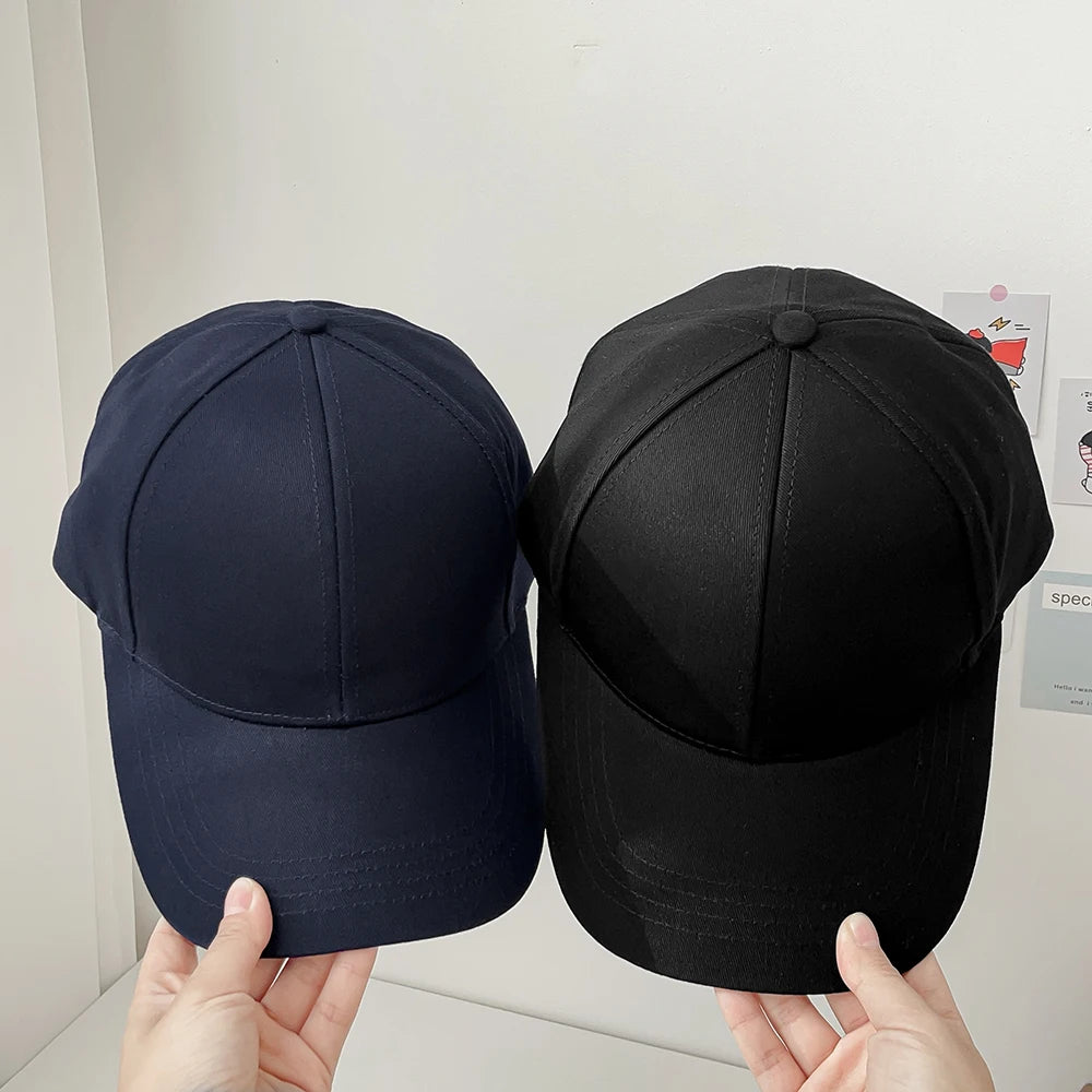 Two SecureShield EMF Blocking Baseball Caps side by side, comparing their colors to showcase the available options.
